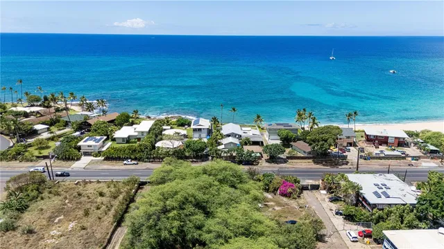 an aerial view of a house with a yard and pool