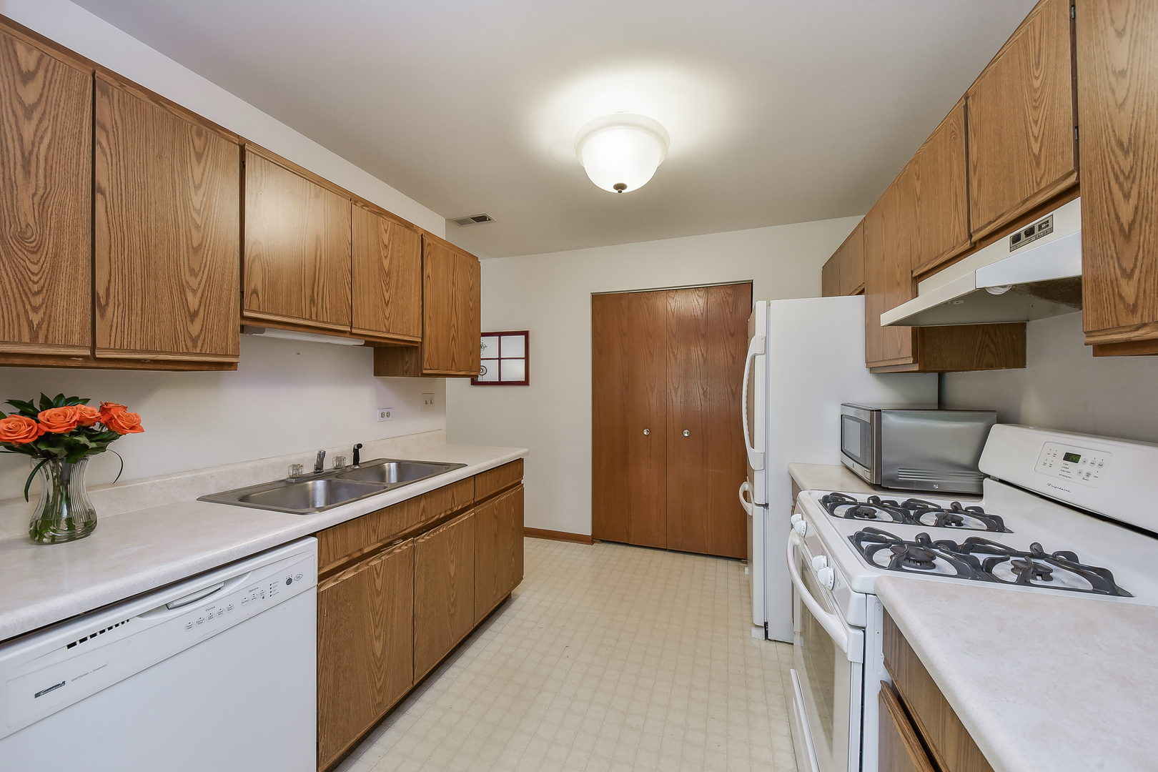 -n159 Windermere Road, Unit 1107 Winfield, IL 60190 - Photo 5 of 14 a kitchen with stainless steel appliances a sink a stove a refrigerator cabinets and a counter top space