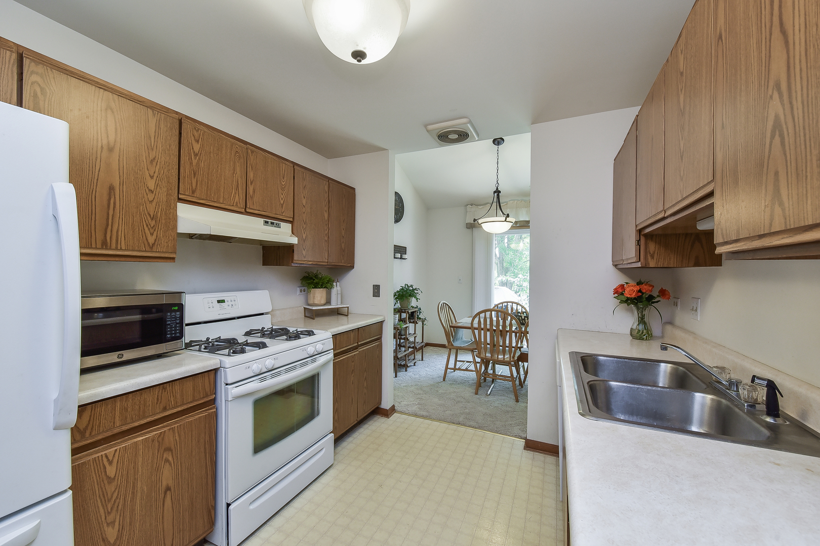 -n159 Windermere Road, Unit 1107 Winfield, IL 60190 - Photo 6 of 14 a kitchen with stainless steel appliances a sink a stove and cabinets