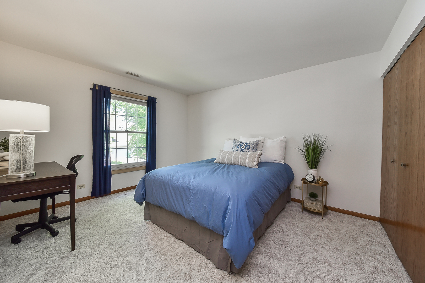 -n159 Windermere Road, Unit 1107 Winfield, IL 60190 - Photo 9 of 14 a bedroom with a bed table chair and a window