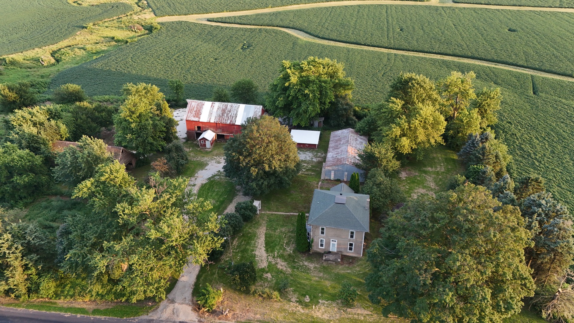 an aerial view of a house with a yard and lake view