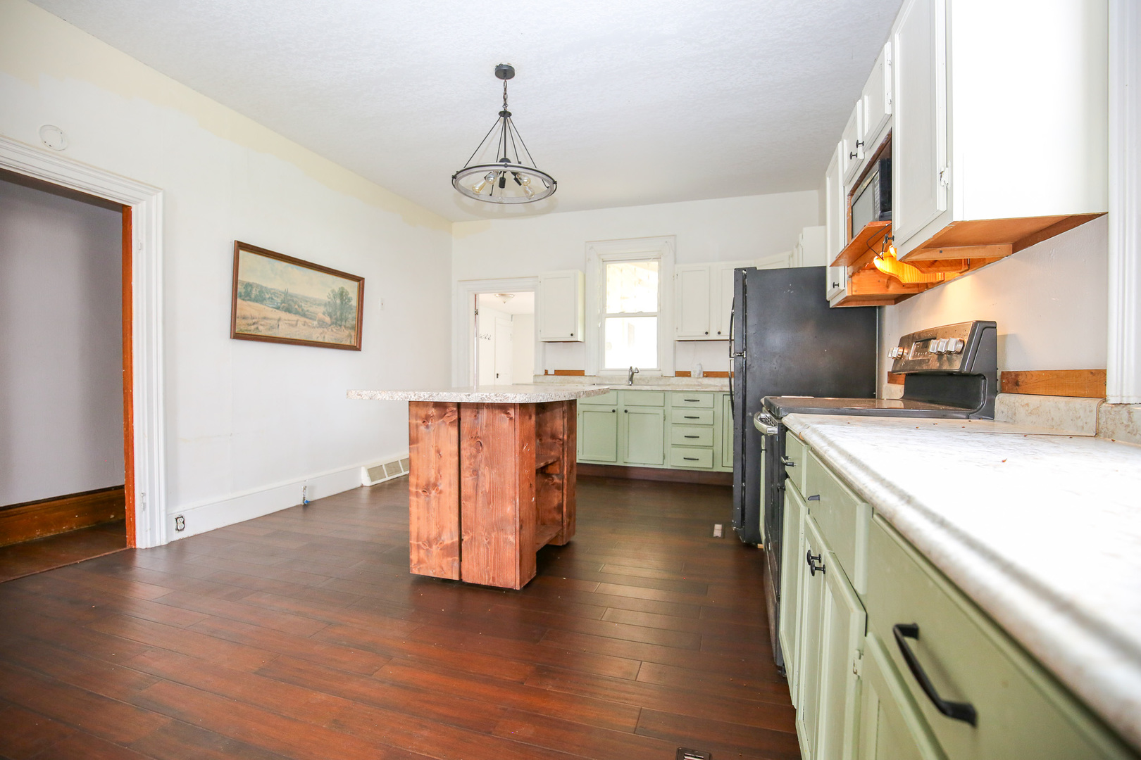 26596 Fairhaven Road Chadwick, IL 61014 - Photo 13 of 51 a kitchen with stainless steel appliances granite countertop a refrigerator a sink dishwasher a stove and a dining table with wooden floor