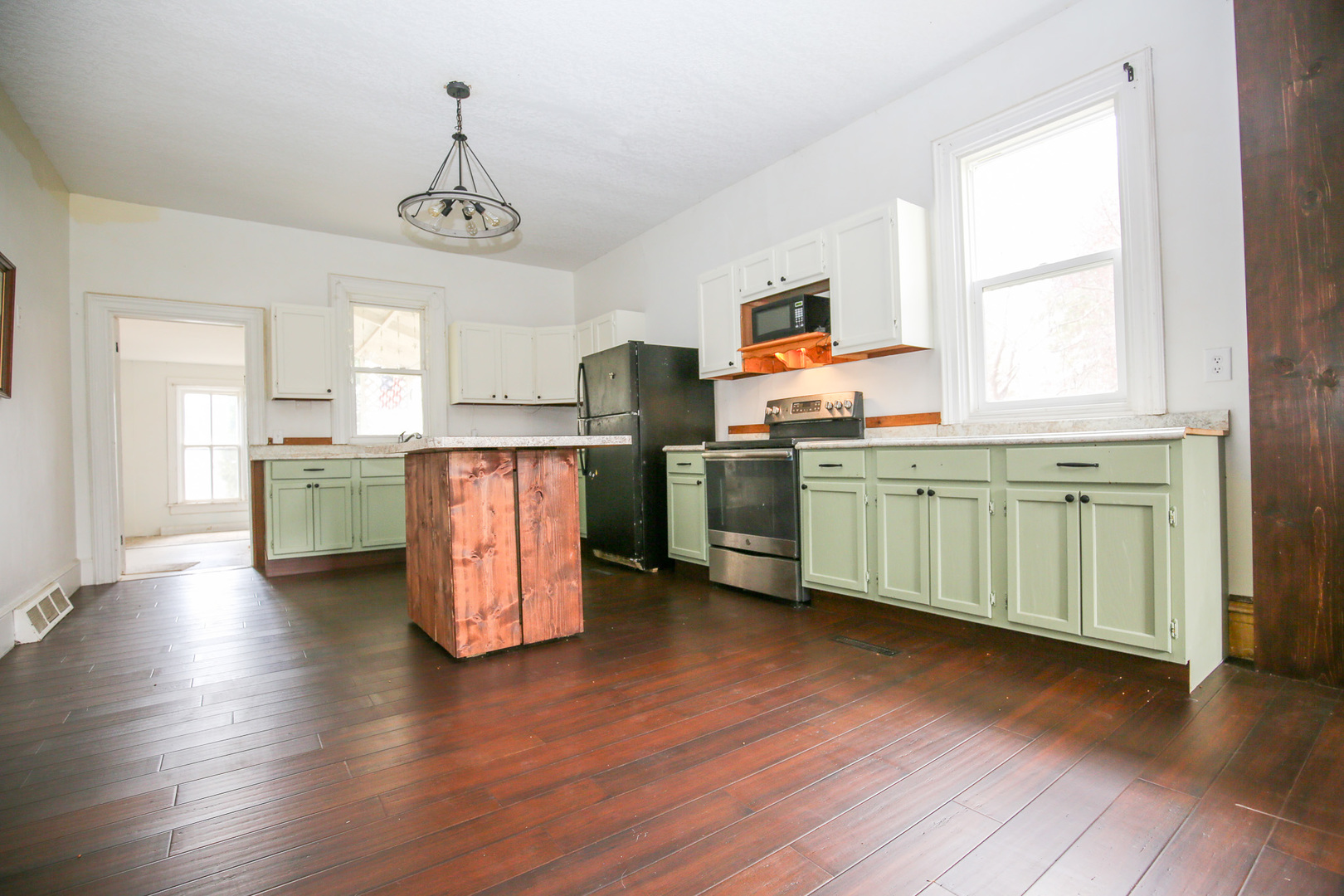 26596 Fairhaven Road Chadwick, IL 61014 - Photo 4 of 51 a kitchen with stainless steel appliances wooden floors and white walls