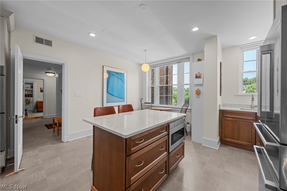 12546 Cedar Road, Unit 4 Cleveland Heights, OH 44106 - Photo 17 of 43 Newer windows, gourmet Kitchen taken down to the studs with center island and breakfast bar, 2 sinks, quartz counters, all Bosch stainless appliances with induction range and 2 ovens for large gatherings