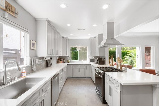 a kitchen with a sink stove top oven and refrigerator