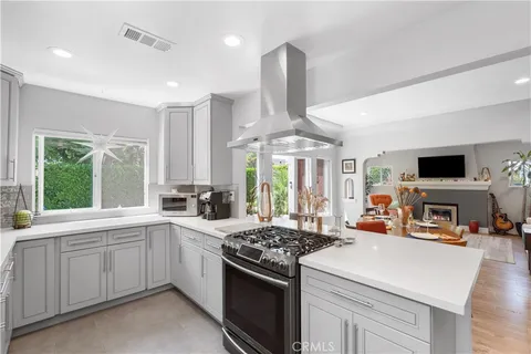 a kitchen with stove a sink and a refrigerator
