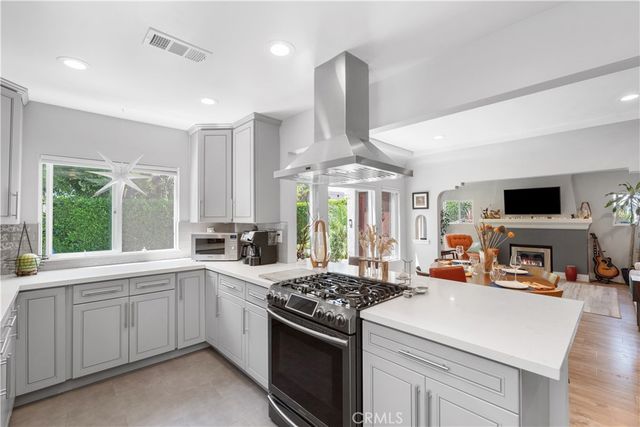 a kitchen with stove a sink and a refrigerator