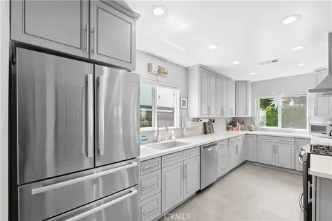 a kitchen with white cabinets and white appliances