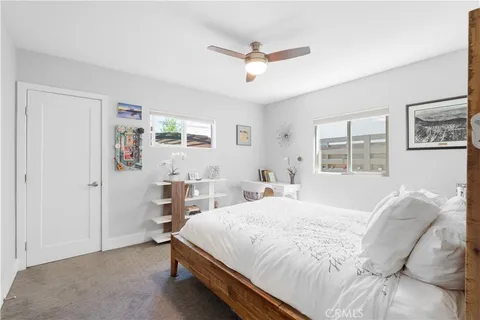 a bed sitting in a bedroom next to a window