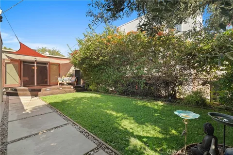 a view of a house with backyard porch and garden
