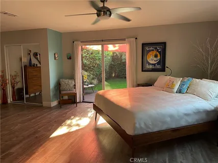 a large bed sitting in a bedroom next to a window