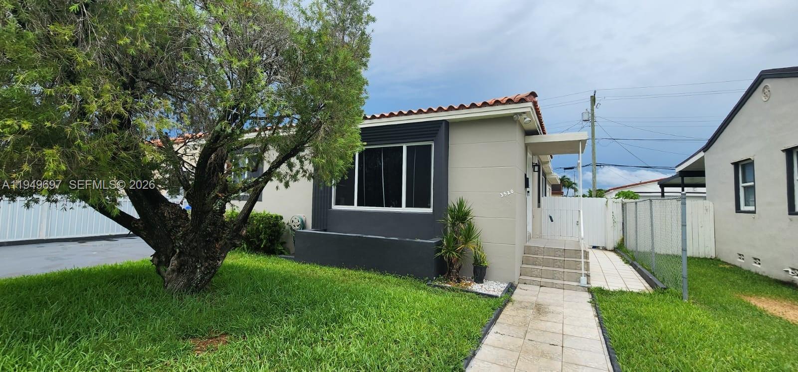 3520 Northwest 20th Street, Unit 2 Miami, FL 33142 - Photo 2 of 10 a view of a house with a yard