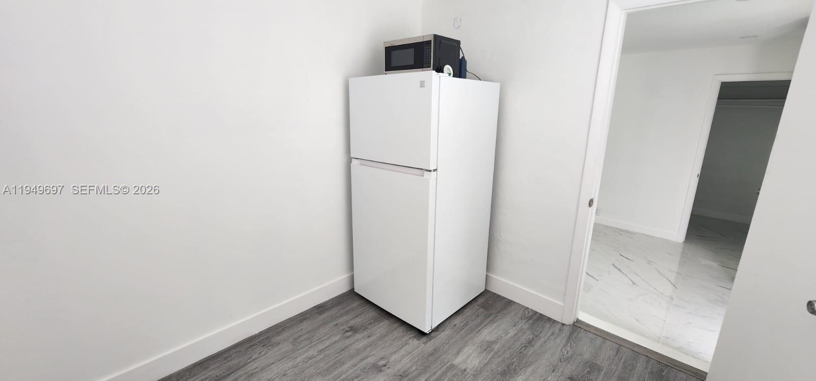 3520 Northwest 20th Street, Unit 2 Miami, FL 33142 - Photo 6 of 10 a view of a room with wooden floor