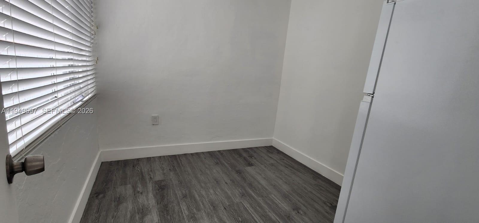 3520 Northwest 20th Street, Unit 2 Miami, FL 33142 - Photo 8 of 10 a view of a small space with wooden floor and a window