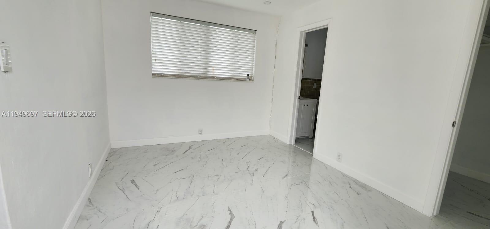 3520 Northwest 20th Street, Unit 2 Miami, FL 33142 - Photo 9 of 10 an empty room with windows