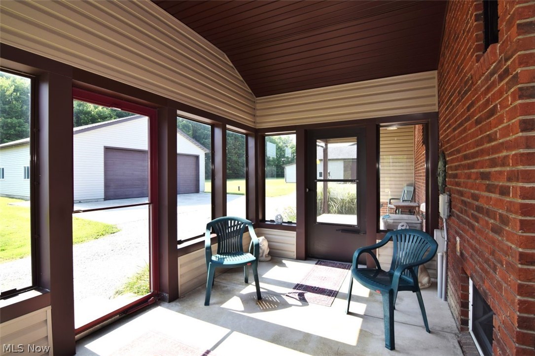 15227 Leroy Road Thompson, OH 44086 - Photo 18 of 50 Glassed in enclosed patio that leads to both the open covered patio and the interior of the home. Andersen storm door.