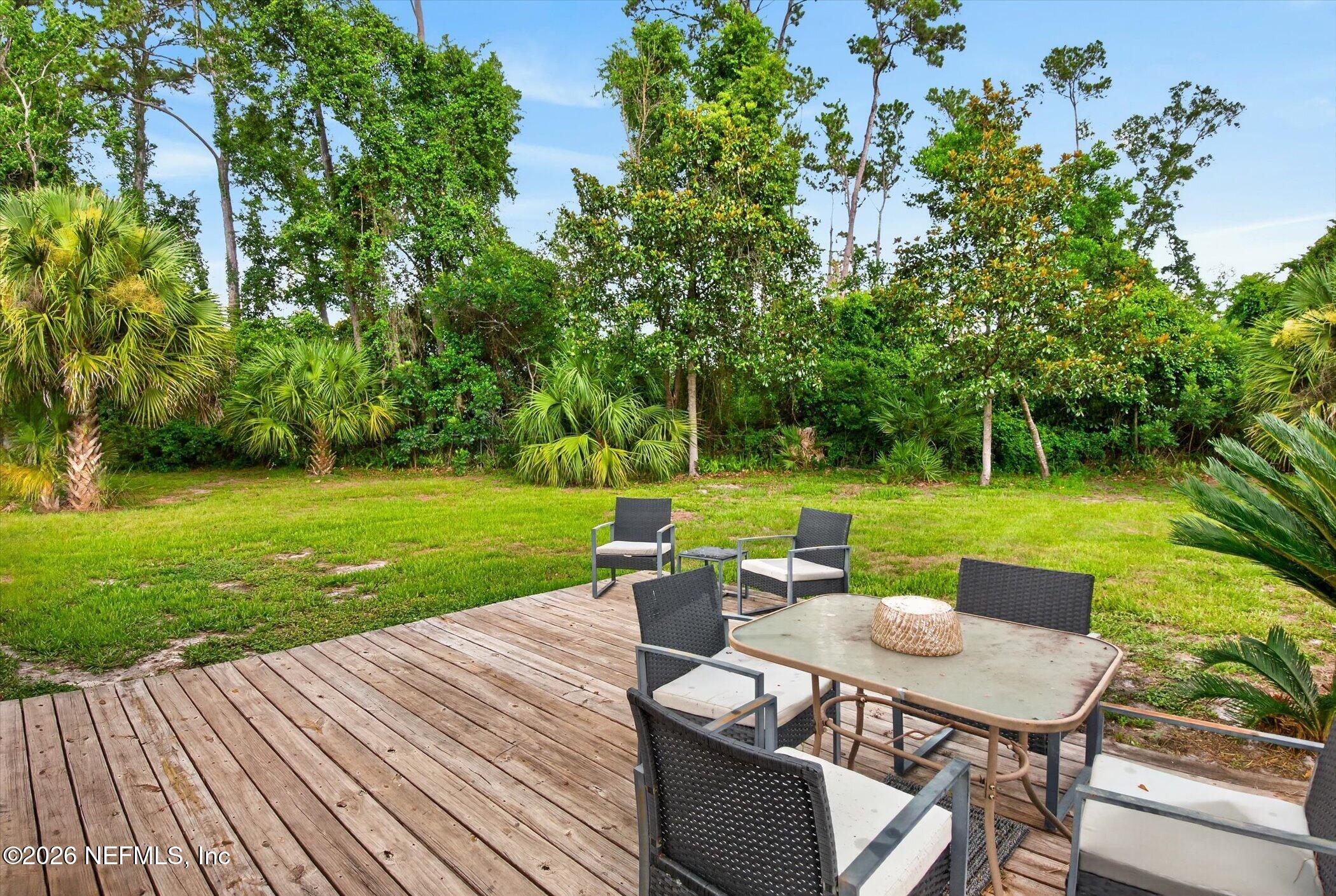 2705 Navajo Road Orange Park, FL 32073 - Photo 51 of 58 a view of a table and chairs on the deck in front of big house