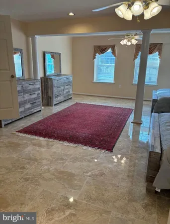 a spacious bedroom with a bed and a dresser