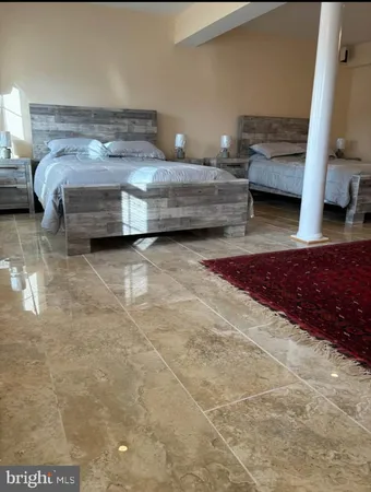 a bedroom with a bed and a couch