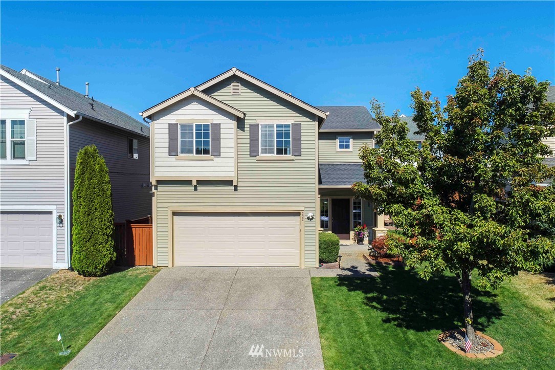 332 Index Avenue Southeast Renton, WA 98056 - Photo 2 of 23 a front view of a house with a yard and garage
