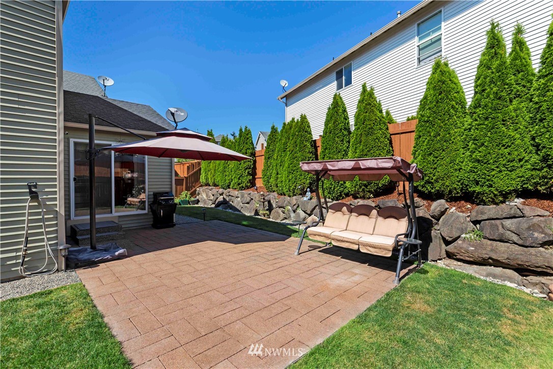 332 Index Avenue Southeast Renton, WA 98056 - Photo 20 of 23 a view of a patio with a table and chairs under an umbrella