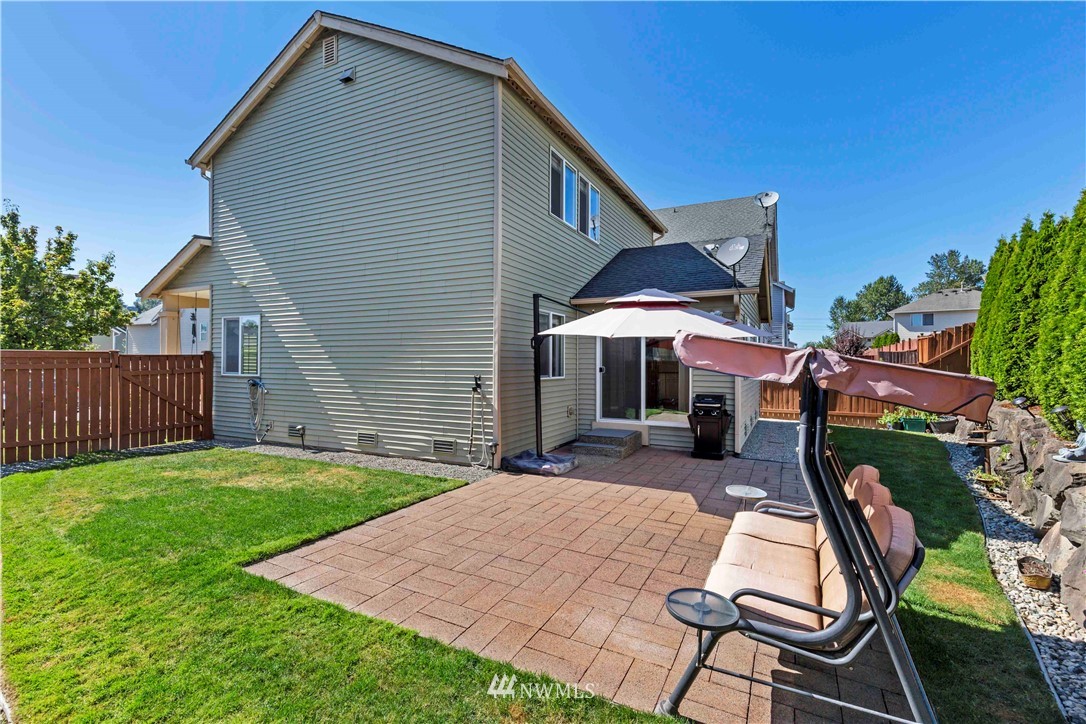 332 Index Avenue Southeast Renton, WA 98056 - Photo 23 of 23 a patio with a table and chairs under an umbrella
