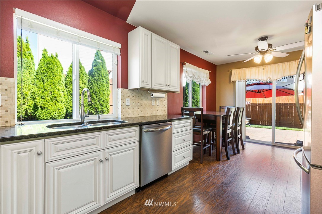 332 Index Avenue Southeast Renton, WA 98056 - Photo 10 of 23 a kitchen with a table chairs sink and cabinets