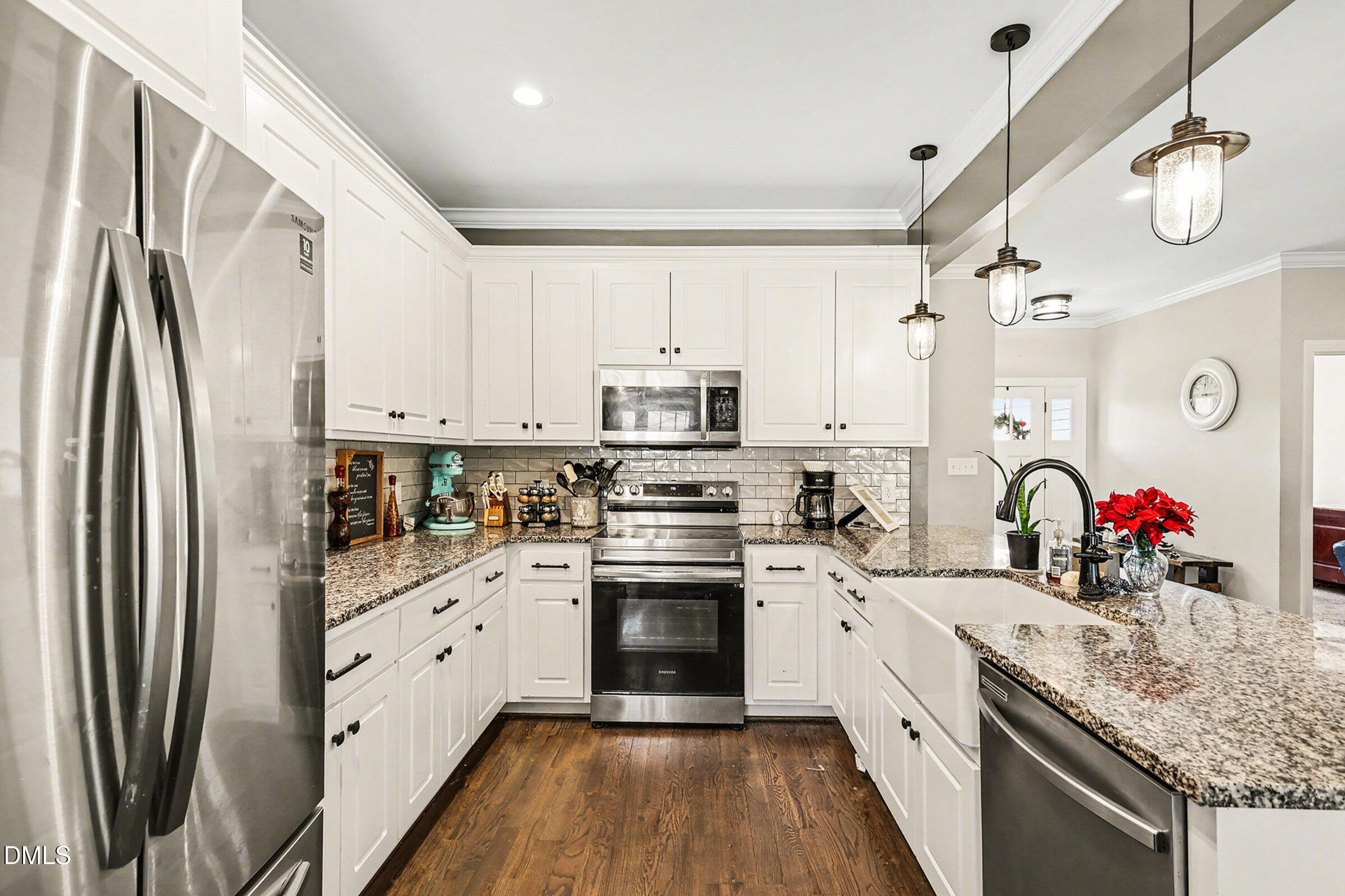 5117 Joe Ellen Road Battleboro, NC 27809 - Photo 8 of 23 a kitchen with stainless steel appliances granite countertop a refrigerator sink and white cabinets