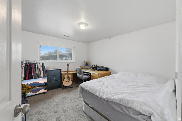 1700 Hickory Lane Provo, UT 84604 - Photo 19 of 20 Carpeted room featuring a white ceiling and walls, a window with horizontal blinds, and a flush-mount ceiling light fixture