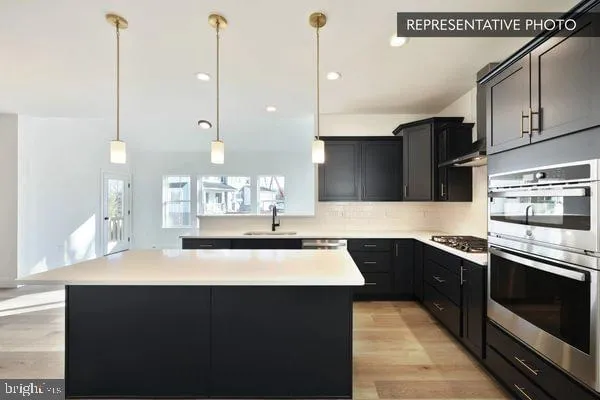 a kitchen with a sink a stove and chairs