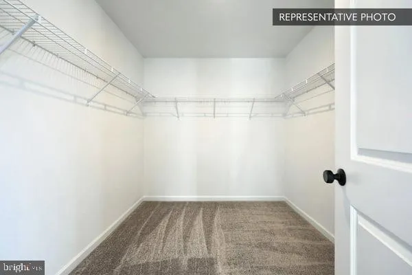 a spacious bathroom with a double vanity sink toilet and a mirror