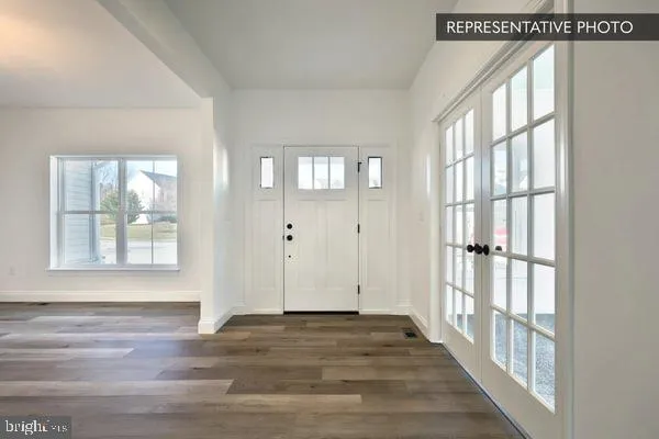 a view of an entryway with wooden floor