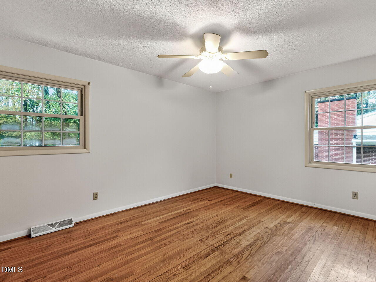 617 South Lakeside Drive Raleigh, NC 27606 - Photo 17 of 32 a view of an empty room with wooden floor and a window