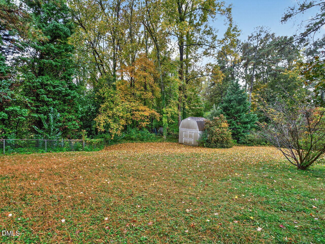 617 South Lakeside Drive Raleigh, NC 27606 - Photo 27 of 32 a backyard of a house with a yard and large tree