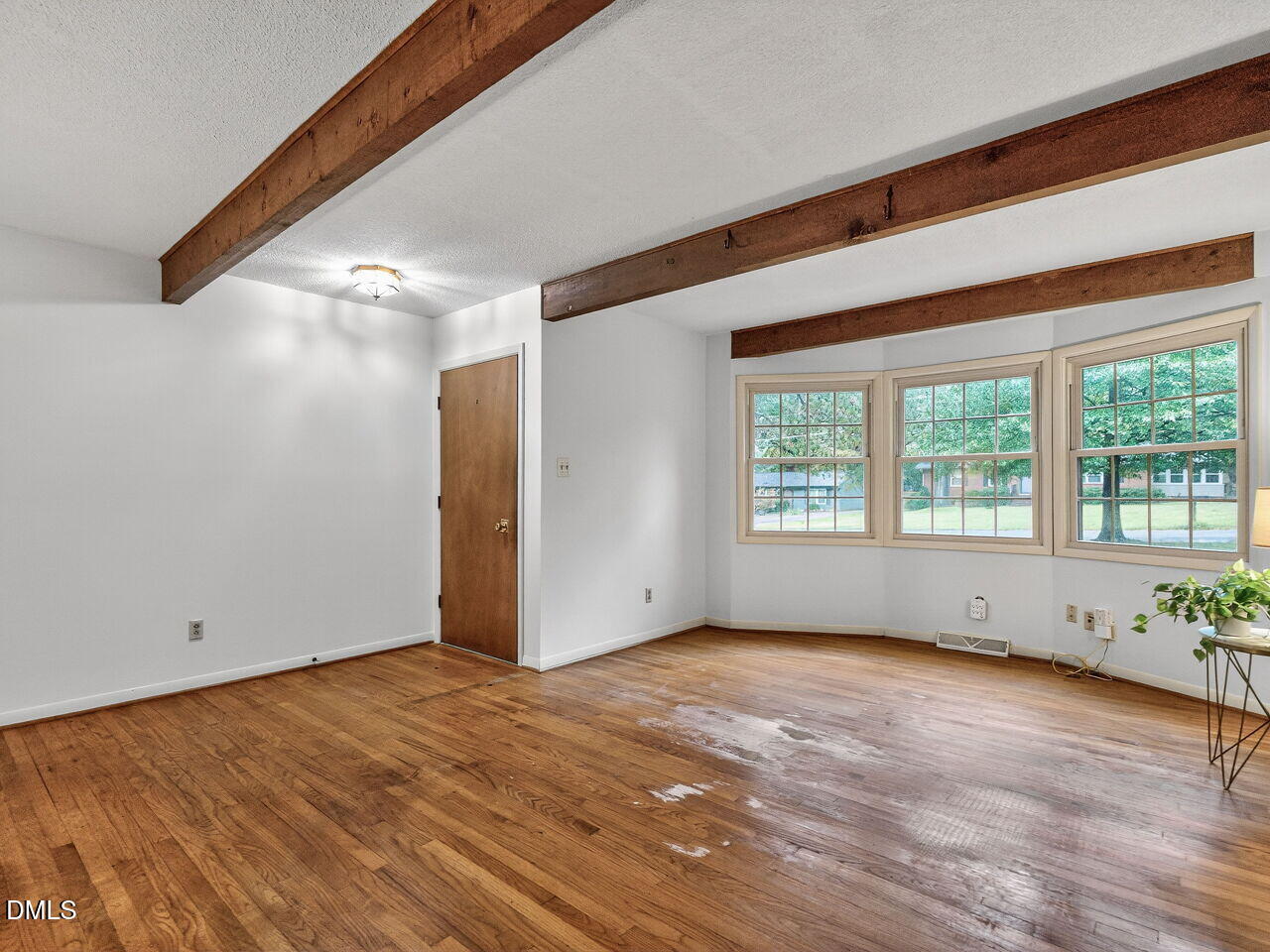 617 South Lakeside Drive Raleigh, NC 27606 - Photo 4 of 32 a view of an empty room with wooden floor and a window