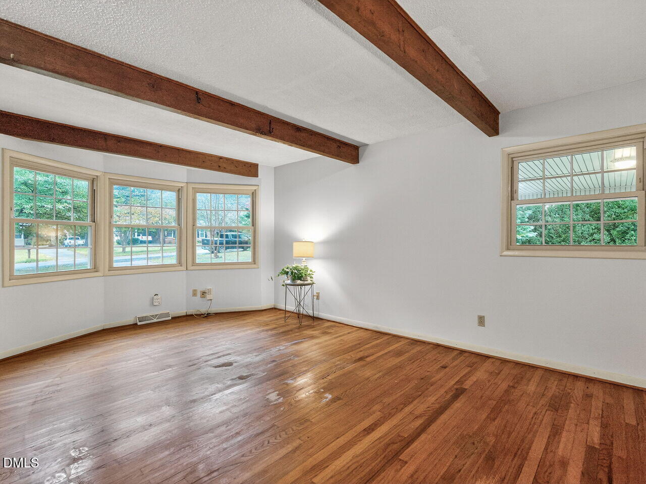 617 South Lakeside Drive Raleigh, NC 27606 - Photo 5 of 32 a view of an empty room with wooden floor and a window