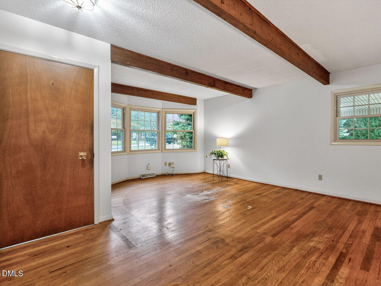 617 South Lakeside Drive Raleigh, NC 27606 - Photo 6 of 32 a view of an empty room with wooden floor and a window