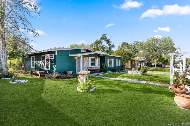 a front view of a house with a garden and porch