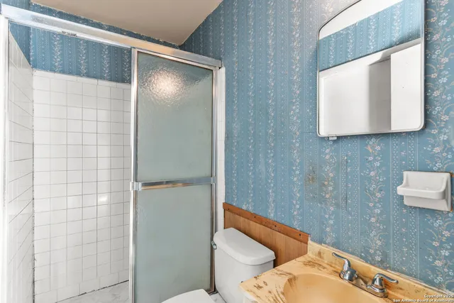 a bathroom with a toilet and a shower