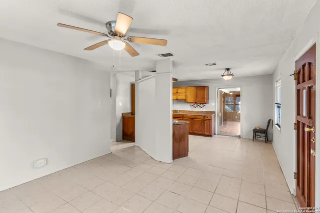 a view of a kitchen with a sink and dishwasher cabinets