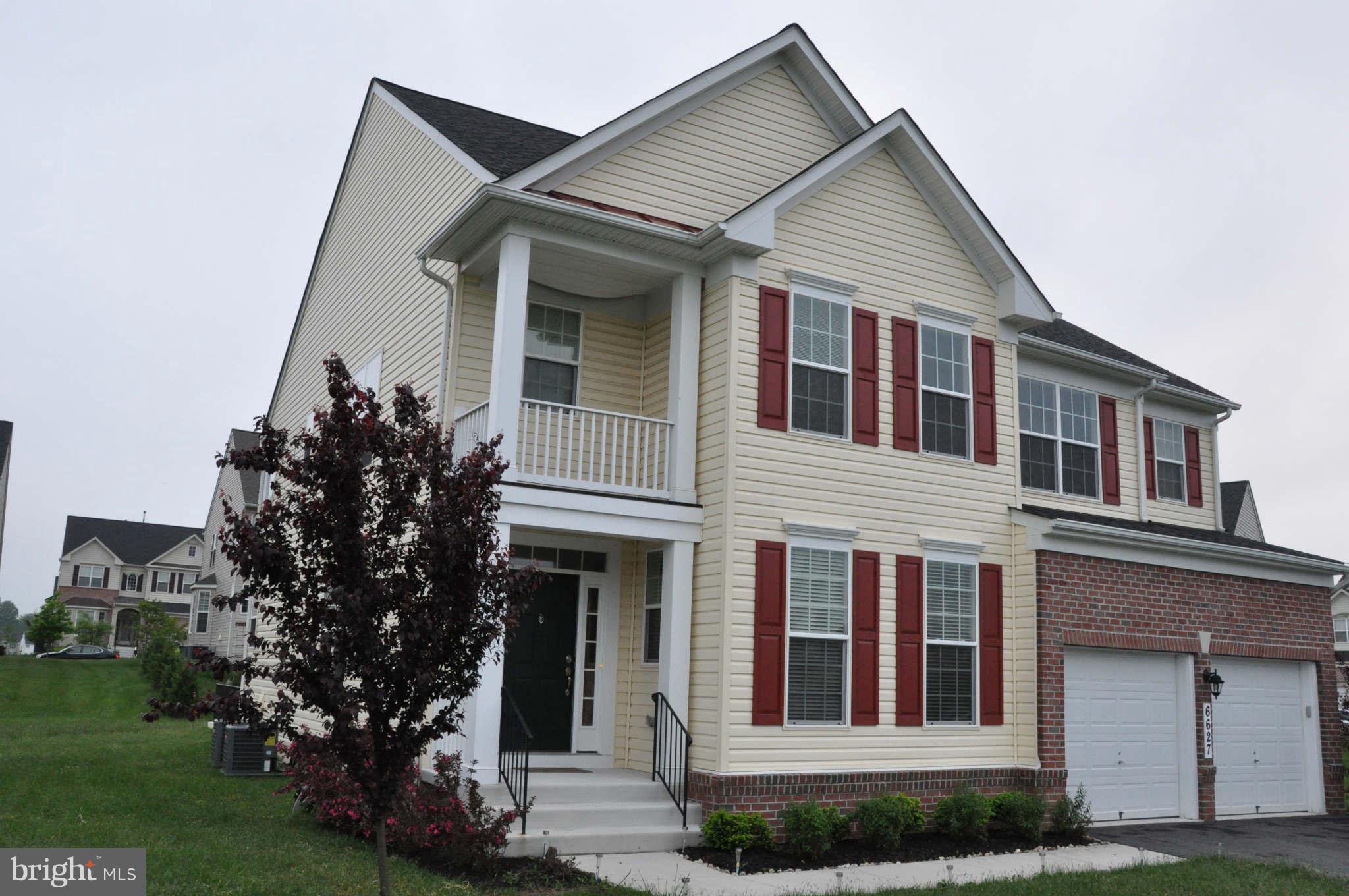 6627 Pebble Brooke Road Baltimore, MD 21209 - Photo 12 of 12 a front view of a house with garden