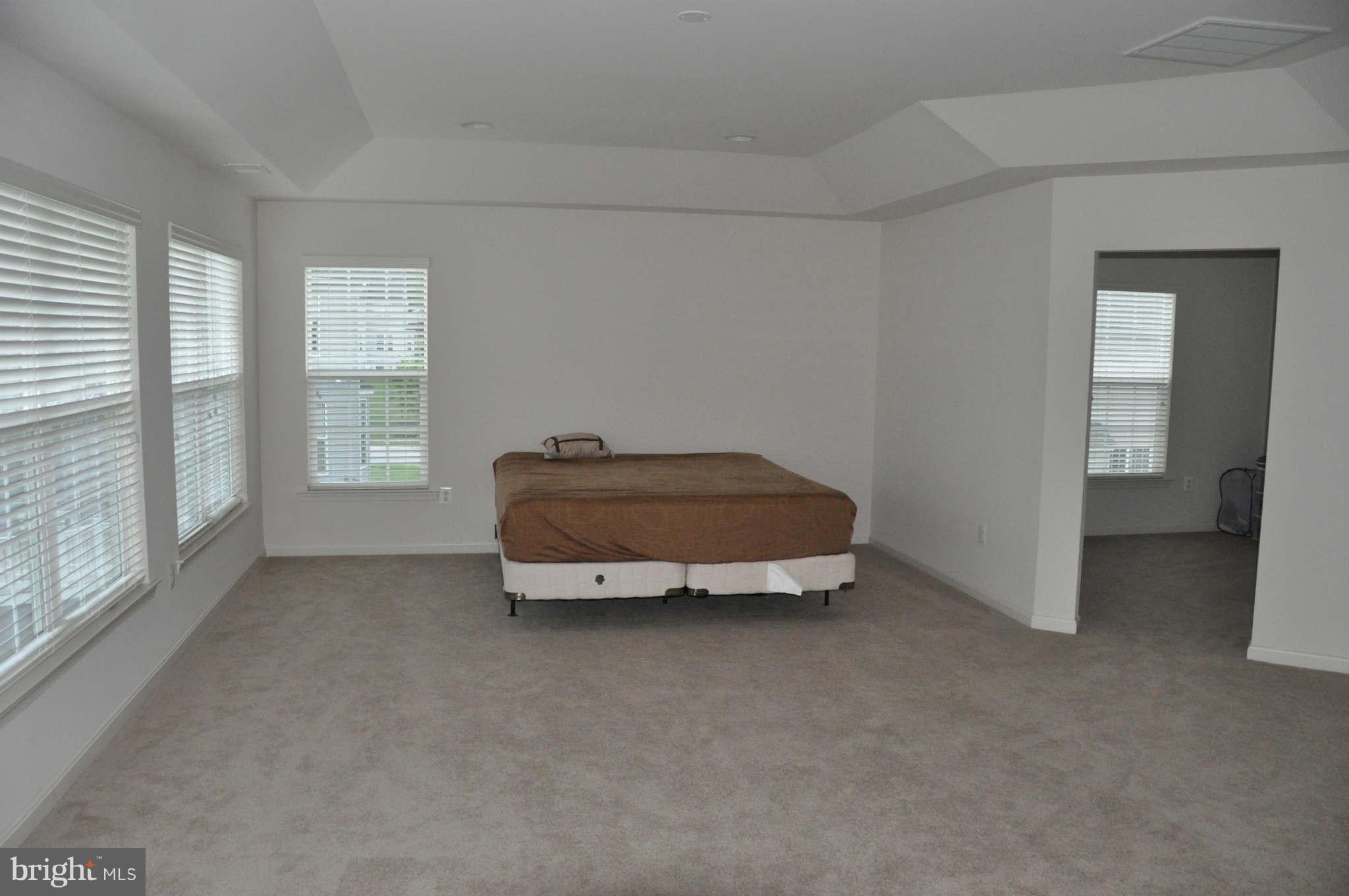 6627 Pebble Brooke Road Baltimore, MD 21209 - Photo 5 of 12 a room with a bed and a large window