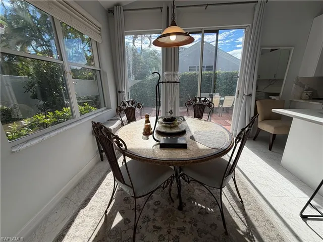 a view of a dining room with furniture wooden floor and a chandelier