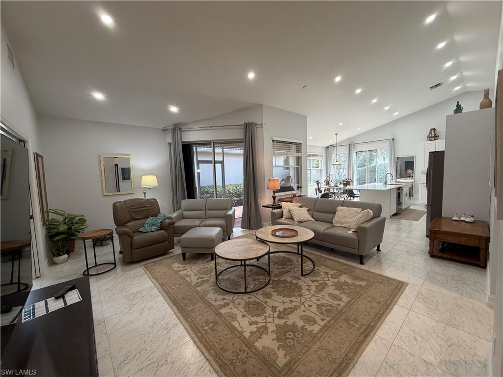 5950 Almaden Drive Naples, FL 34119 - Photo 14 of 41 a living room with furniture and a flat screen tv