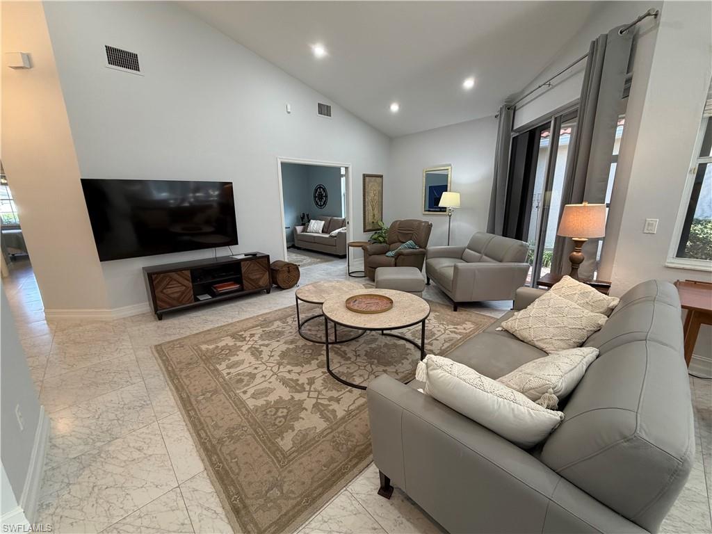 5950 Almaden Drive Naples, FL 34119 - Photo 18 of 41 a living room with furniture and a flat screen tv