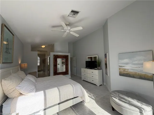 a bedroom with a large bed and a television