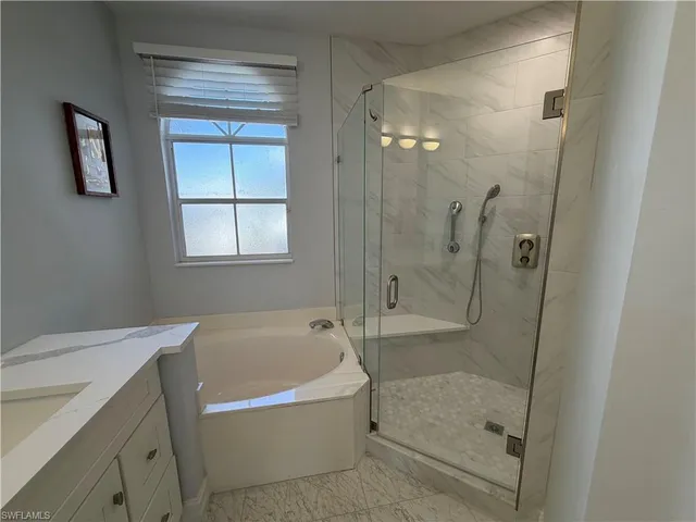 a bathroom with a bathtub and a shower