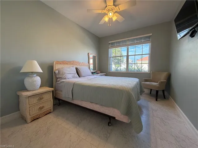 a bedroom with a bed dresser and a window