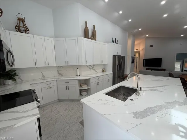 a kitchen that has a sink and a stove in it