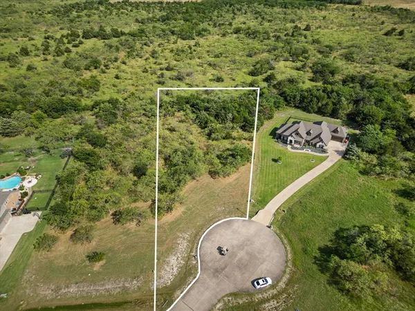 an aerial view of a residential houses with outdoor space